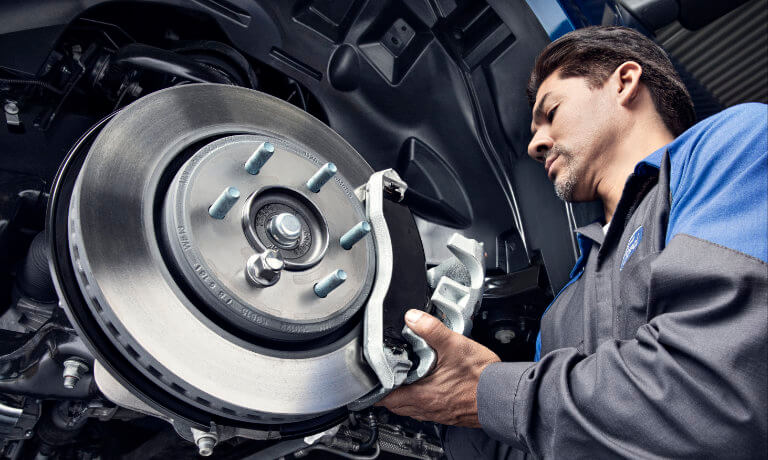 Ford technician working on brake pads