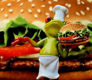 a frog holding a burger in front of a burger